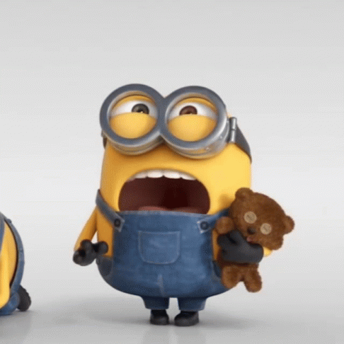 A Minion Holding A Teddy Bear In His Hands GIF