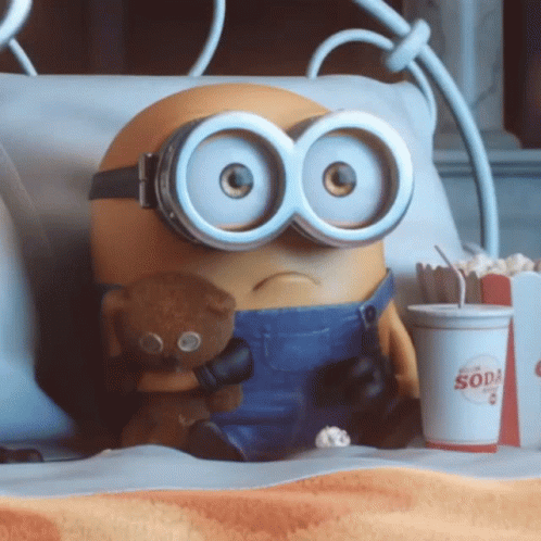 A Minion Holding A Teddy Bear Next To A Cup That Says Soda On It GIF