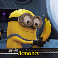 Minion Holding Banana In Front Of Keyboard GIF