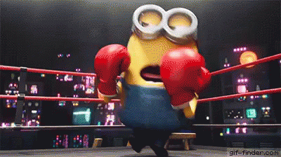 A Minion Is Wearing Red Boxing Gloves In A Ring . GIF