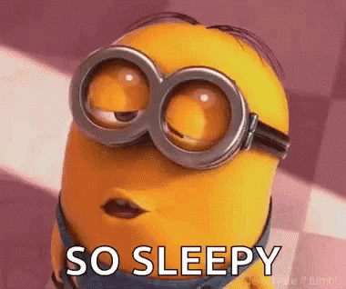 a minion wearing goggles is saying `` so sleepy '' with his eyes closed .