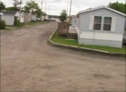 A Mobile Home Sits On The Side Of A Road GIF