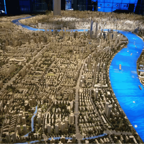 A Model Of A City With A River And A Lot Of Buildings GIF