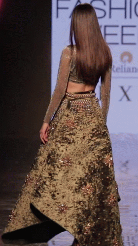 A Model Walks Down The Runway At A Fashion Week GIF