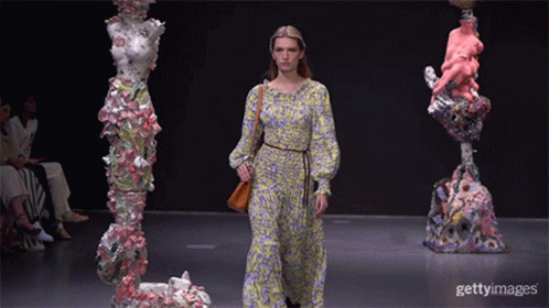 A Model Walks The Runway At A Fashion Show GIF