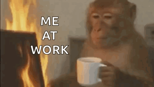 A Monkey Is Holding A Cup Of Coffee And Sitting In Front Of A Fire . GIF