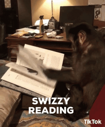 A Monkey Is Reading A Book With The Words Swizzy Reading Below It GIF