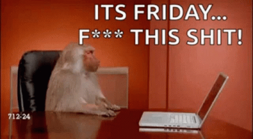 A Monkey Is Sitting At A Desk In Front Of A Laptop With The Words " It 'S Friday F *** This Shit " GIF