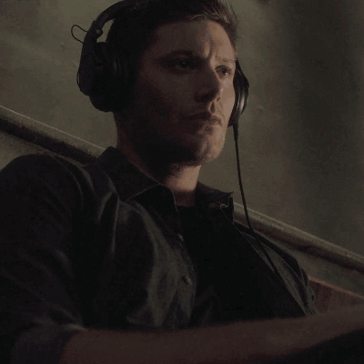 A Monkey Is Wearing Headphones And Holding A Microphone In Its Hand . GIF