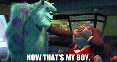 a monster from the movie monsters inc is standing next to a man in a tuxedo .