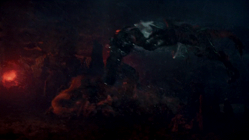 A Monster Is Fighting Another Monster In A Dark Scene GIF