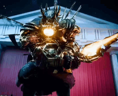 A Monster Is Standing In Front Of A Building With A Red Curtain And A Light On It 'S Head . GIF