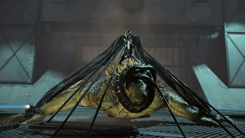 A Monster With A Snake In Its Mouth Is Being Lifted By A Person GIF