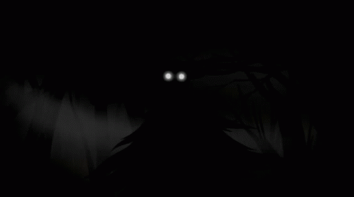 A Monster With Glowing Eyes Is Coming Out Of The Woods In The Dark . GIF