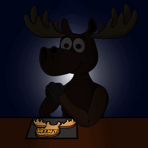 A Moose Sitting At A Table With A Mint Cookie On It 'S Head GIF
