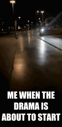 A Motorcycle Is Driving Down A Street At Night With A Caption That Says Me When The Drama Is About To Start . GIF