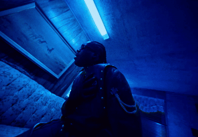 A Motorcycle Is Parked In The Dark With A Person Standing Behind It GIF