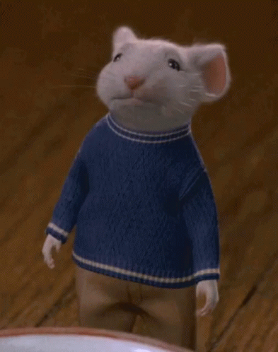 A Mouse Wearing A Blue Sweater Is Waving His Hand GIF