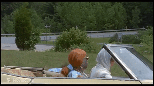 A Movie Clip Of Two Women Driving A Convertible GIF