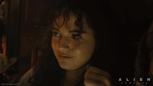 A Movie Poster For Alien Romulus Shows A Woman Giving The Thumbs Up GIF