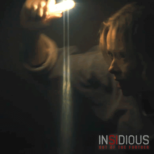 A Movie Poster For Insidious Out Of The Further Shows A Woman Holding A Flashlight GIF