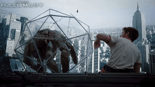 A Movie Poster For Project Hailmary Shows A Man Looking At A Monster In A Cage GIF