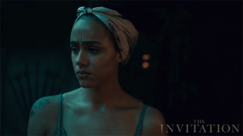 A Movie Poster For The Invitation Features A Woman Wearing A Scarf Around Her Head GIF