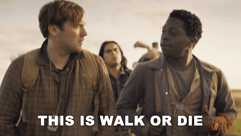 A Movie Poster For The Long Walk Shows Two Men Standing Next To Each Other And Says This Is Walk Or Die GIF