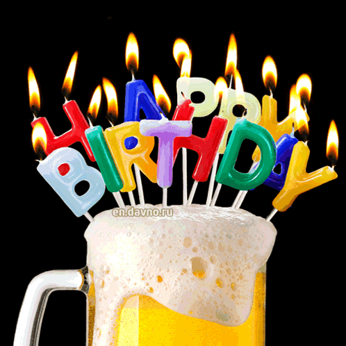 A Mug Of Beer With Birthday Candles On Top GIF