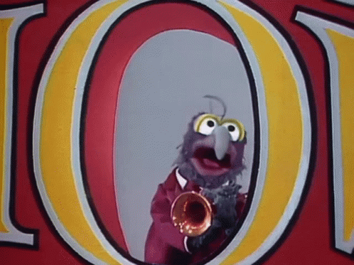 a muppet is playing a trumpet in front of a sign that says loot