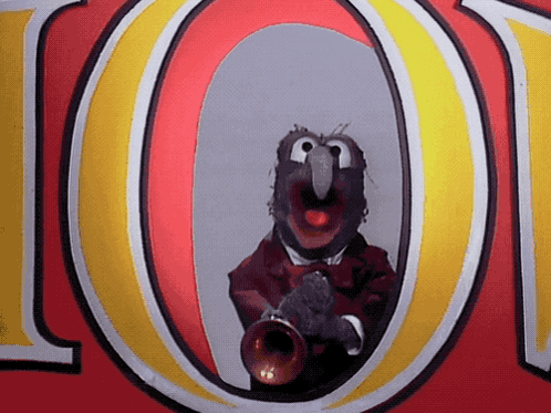 a muppet is playing a trumpet in front of the letter o.