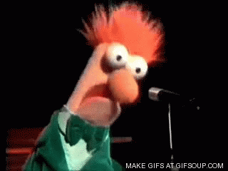 A Muppet Is Singing Into A Microphone While Wearing A Green Tuxedo And Bow Tie . GIF