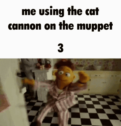 A Muppet Is Sitting On A Checkered Floor In A Kitchen And Using The Cat Cannon On The Muppet Show . GIF