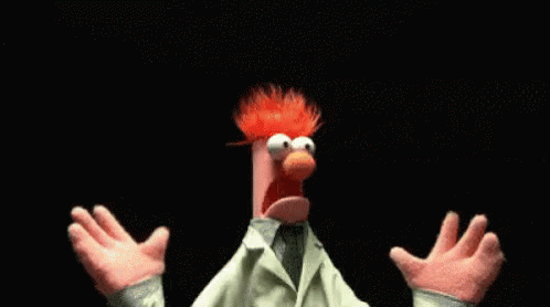 A Muppet With Red Hair And A White Coat Is Standing With His Arms Outstretched . GIF