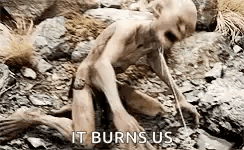 A Naked Man Is Crawling On The Ground In The Dirt . GIF