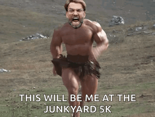 A Naked Man Is Running In A Field With The Words This Will Be Me At The Junkyard 5K Below Him GIF