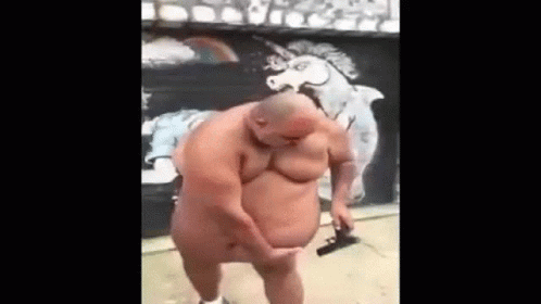 A Naked Man Is Standing In Front Of A Mural Of A Unicorn On A Wall . GIF