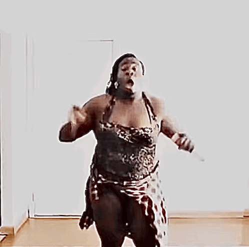 a naked woman is jumping in the air with her arms outstretched
