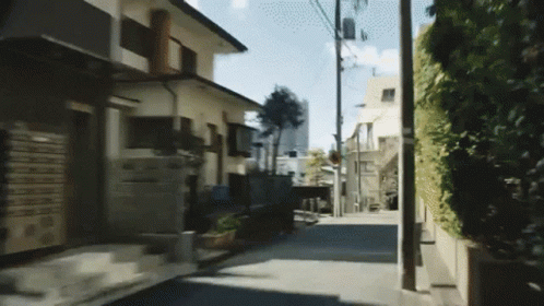 A Narrow Street With A Few Houses On The Side GIF