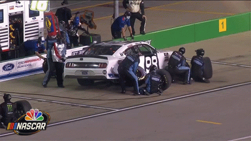 A Nascar Race Car Is Being Worked On By Mechanics GIF