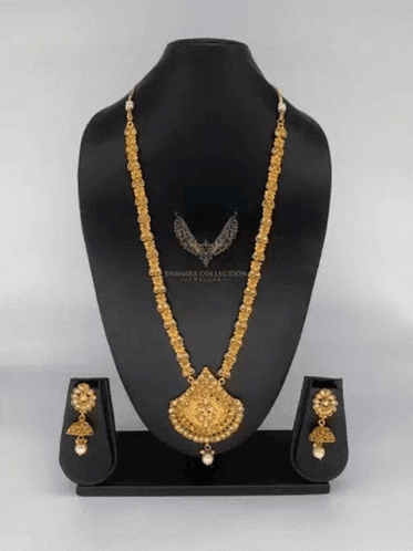 A Necklace And Earring Set Is On A Mannequin With The Word Sahara Collection On It GIF