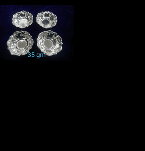 A Necklace And Earrings Are Displayed On A Black Velvet Shelf GIF