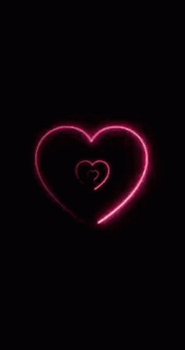 A Neon Heart Is Glowing In The Dark On A Black Background GIF