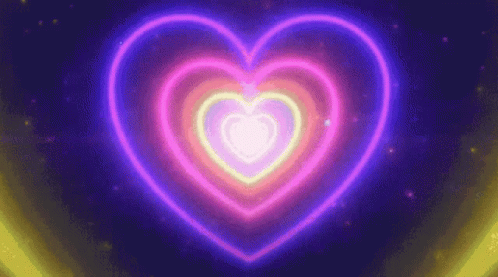 A Neon Heart Is Glowing In The Dark On A Dark Background GIF