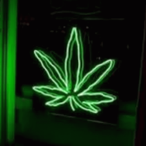 A Neon Sign Of A Hand Crossing Its Fingers In A Green Room . GIF
