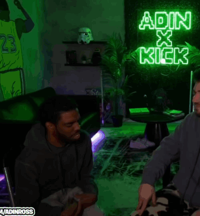 A Neon Sign That Says ' Adin X Kick ' Is Lit Up In A Dark Room GIF