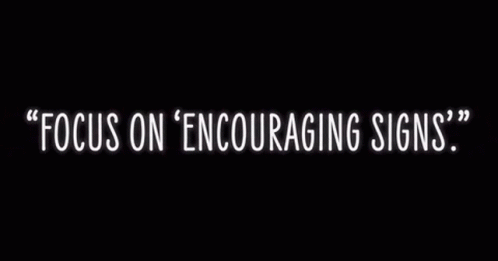 A Neon Sign That Says Focus On Encouraging Signs On A Black Background GIF