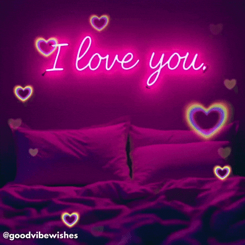 A Neon Sign That Says I Love You Is Above A Bed GIF