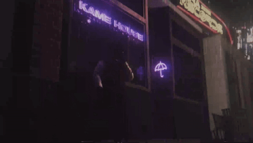 A Neon Sign That Says Kame House With An Umbrella On It GIF