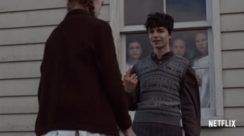 A Netflix Ad Shows A Boy And A Woman Holding Hands GIF